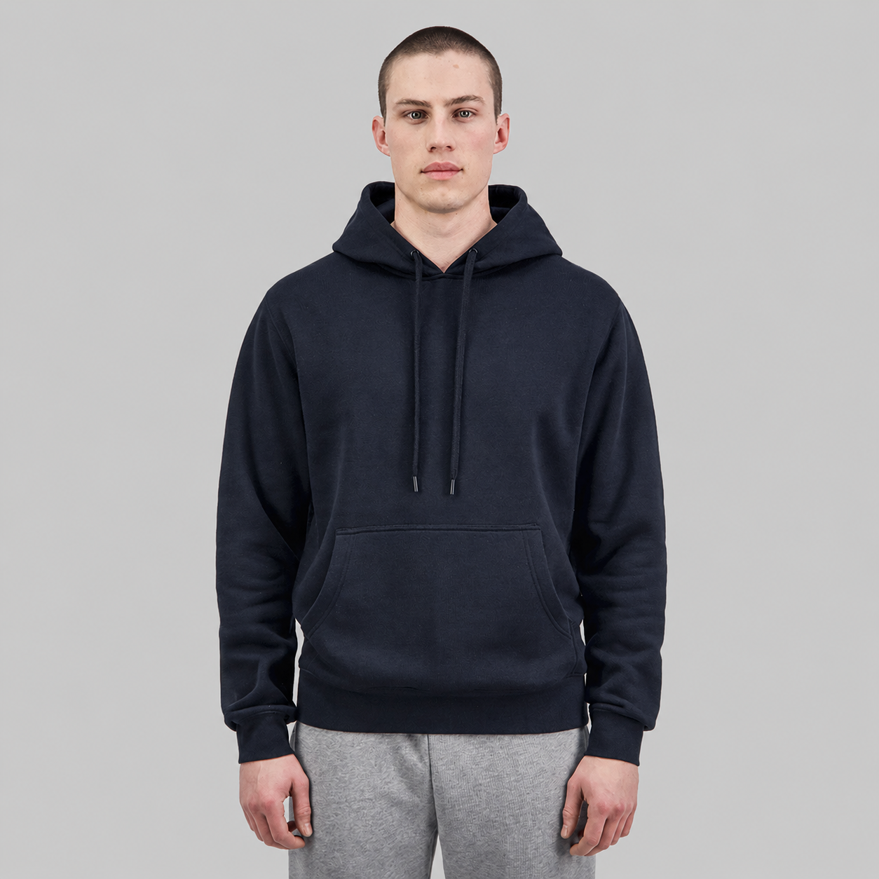 Studio product image of the Navy Mens Everyday Hoodie, featuring a relaxed fit, soft 350 GSM brushed fleece construction, adjustable hood with drawcord, ribbed cuffs and hem, and a classic front kangaroo pocket.